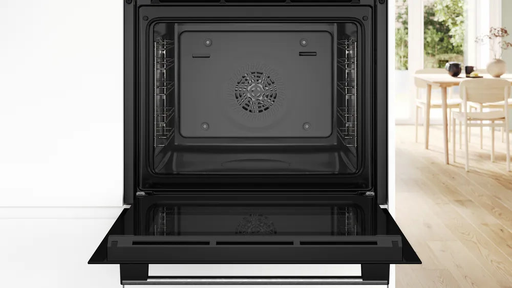 Inside of Bosch Built-in Electric Single Black oven in a kitchen setting with a blurred background